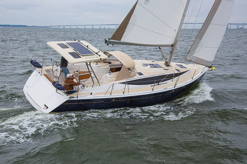 Slide: The Image of 2014 Marlow-Hunter 40 sailboat navigating open waters with bridge in background. - 3