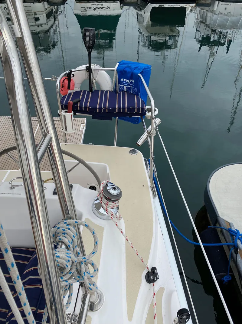 Slide: The Image of 2014 Marlow Hunter 40 sailboat docked, featuring deck details and mooring lines. - 30