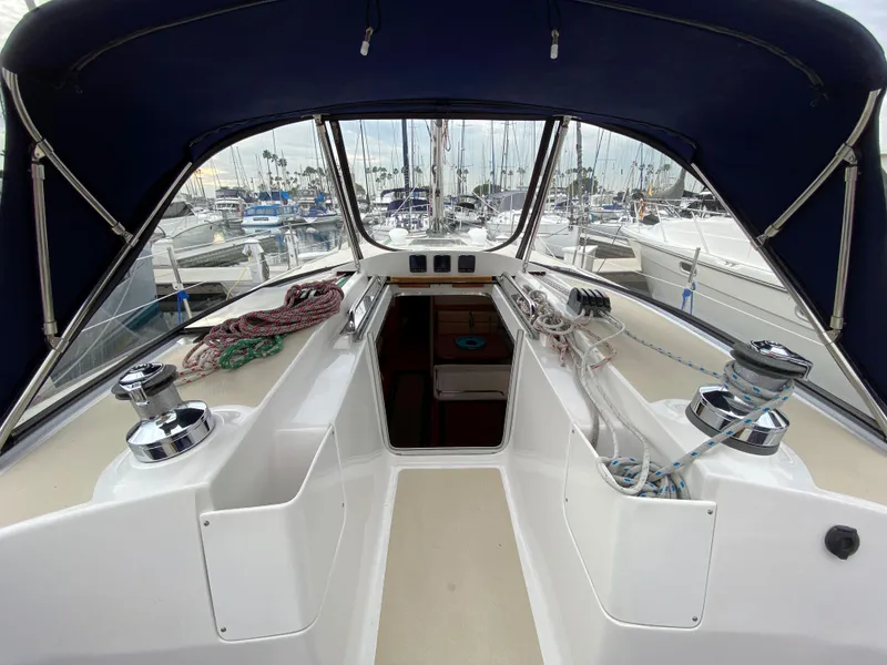 Slide: The Image of 2014 Marlow-Hunter 40 sailboat cockpit with blue canopy and marina view. - 41