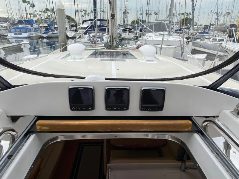Slide: The Image of 2014 Marlow Hunter 40 sailboat cockpit with navigation instruments, docked in a marina. - 42