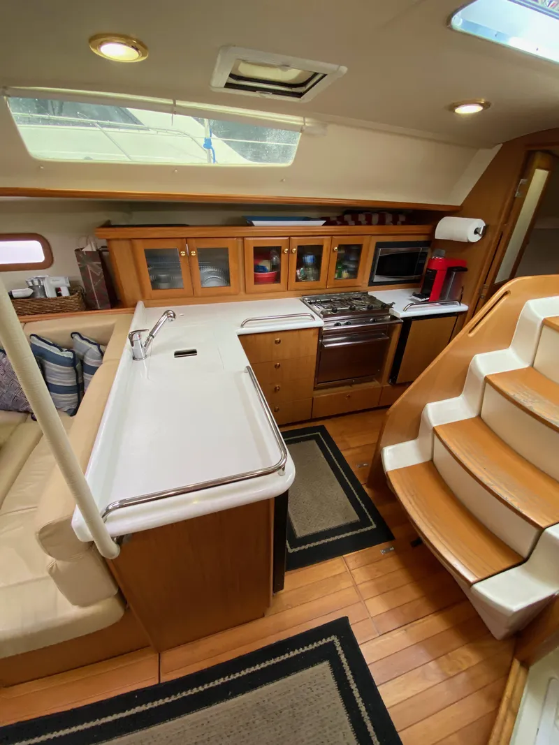 Slide: The Image of Interior of 2014 Marlow Hunter 40 sailboat with modern kitchen and wooden cabinetry. - 46