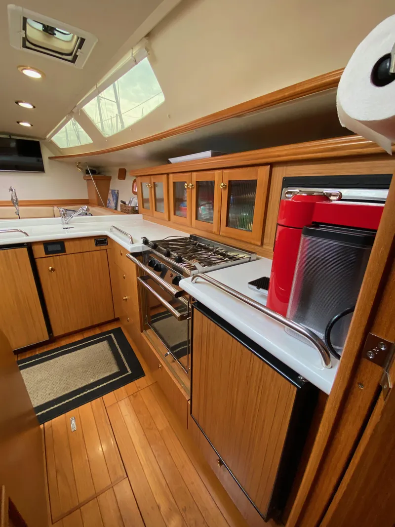Slide: The Image of 2014 Marlow Hunter 40 yacht kitchen with wood cabinetry and modern appliances. - 47