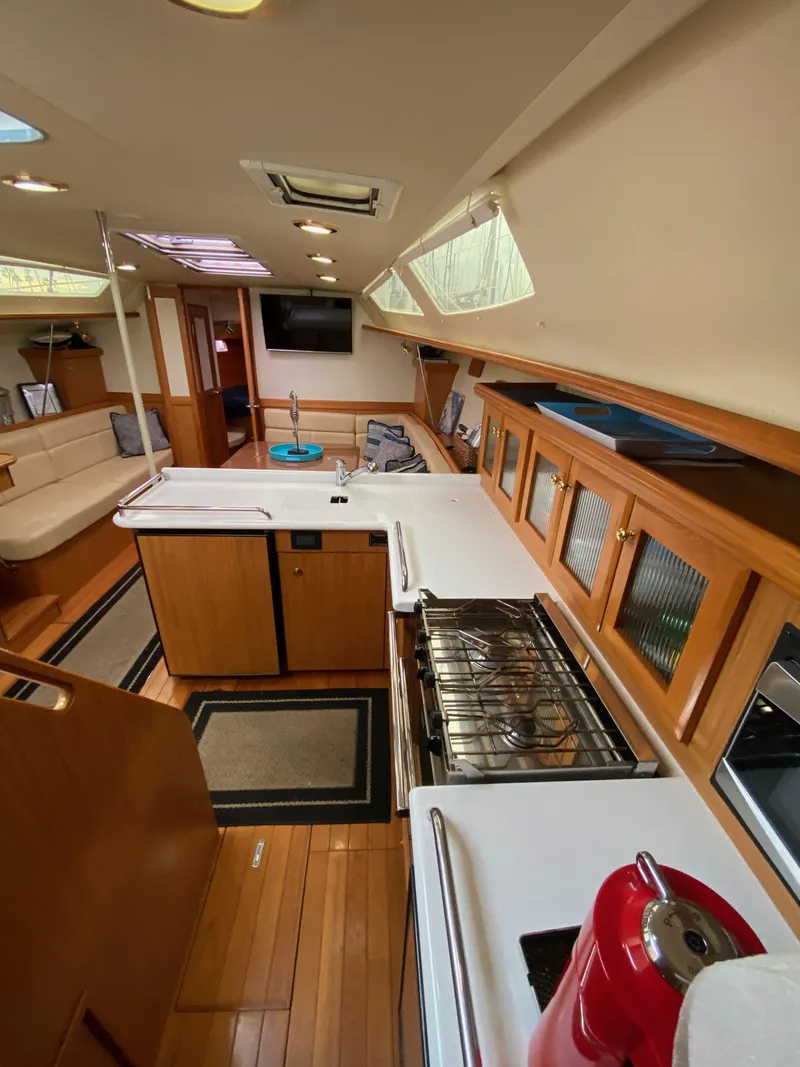 Slide: The Image of Interior of 2014 Marlow Hunter 40 sailboat with modern kitchen and wooden finishes. - 48