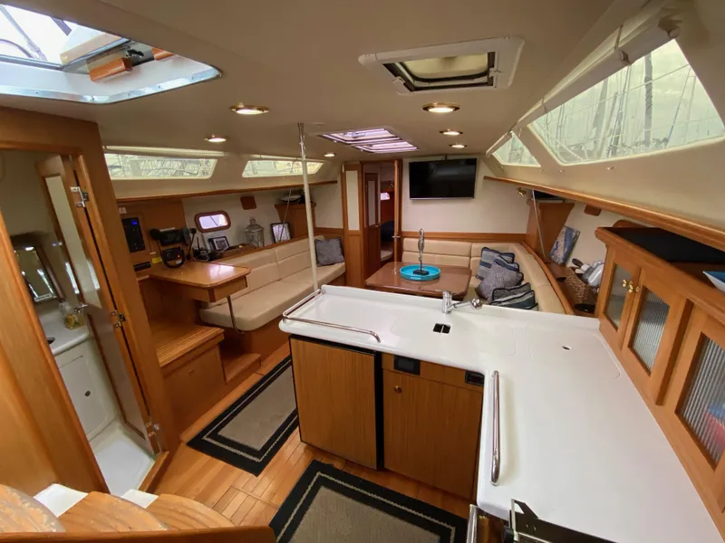 Slide: The Image of Interior of 2014 Marlow Hunter 40 sailboat with modern kitchen and cozy seating area. - 49