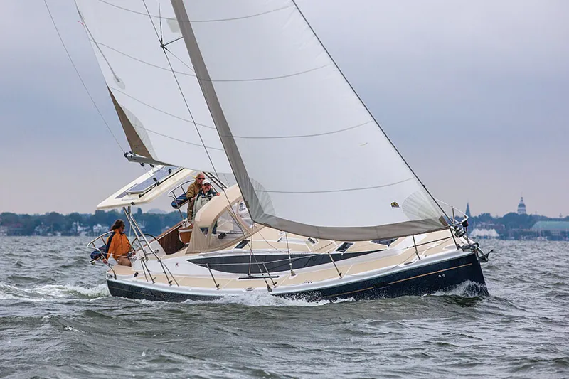 Slide: The Image of 2014 Marlow Hunter 40 sailboat navigating choppy waters under cloudy skies. - 6