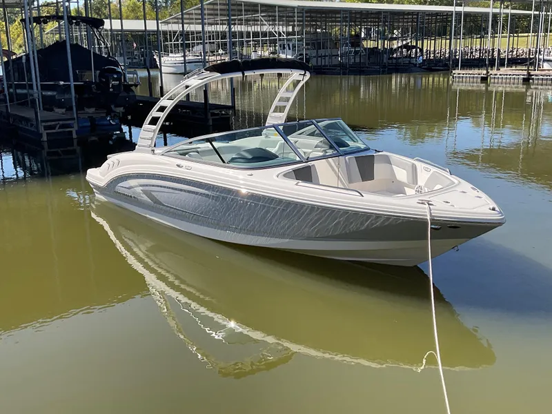 Slide: The Image of 2024 Chaparral 23 SSi boat docked on calm water. - 0