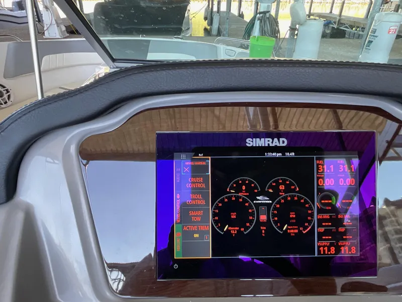 Slide: The Image of 2024 Chaparral 23 SSi dashboard with Simrad display showing controls and gauges. - 13