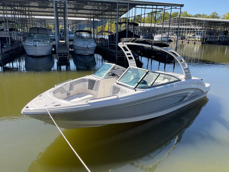 Slide: The Image of 2024 Chaparral 23 SSi boat docked in marina, sleek design, calm water. - 17