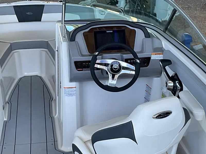 Slide: The Image of 2024 Chaparral 23 SSi boat interior with steering wheel and dashboard. - 3