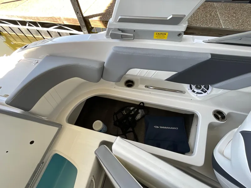 Slide: The Image of 2024 Chaparral 23 SSi boat interior storage compartment with open lid. - 5