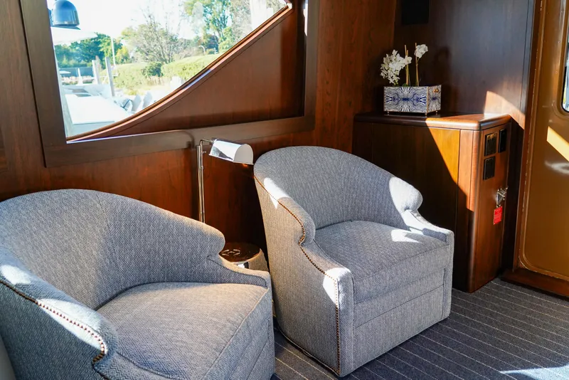 Slide: The Image of Interior of 1999 Hatteras 70 Convertible yacht with elegant seating and wooden accents. - 14