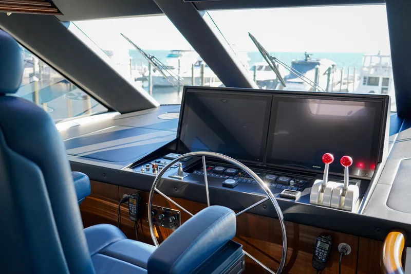 Slide: The Image of Helm of 1999 Hatteras 70 Convertible yacht with dual screens and controls. - 44
