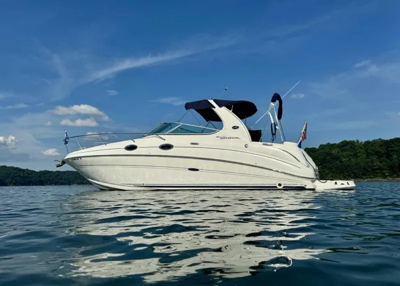 Slide: The Image of 2005 Sea Ray 280 DA boat on calm water under blue sky. - 1