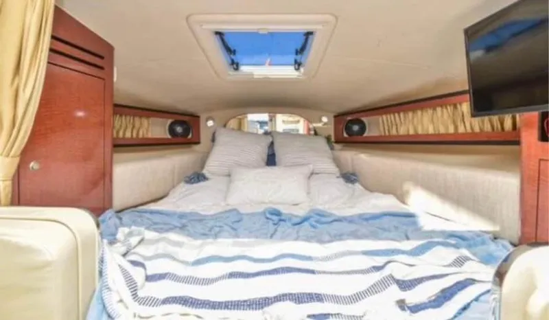 Slide: The Image of Interior cabin of 2005 Sea Ray 280 DA with cozy bedding and skylight. - 10