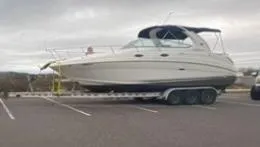 Slide: The Image of 2005 Sea Ray 280 DA boat on trailer in parking lot. - 2