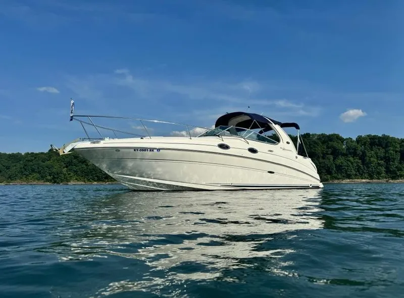 Slide: The Image of 2005 Sea Ray 280 DA boat on calm water, clear sky background. - 3