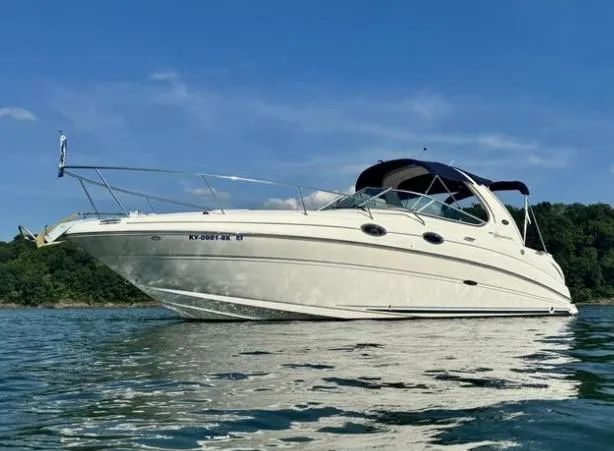 Slide: The Image of 2005 Sea Ray 280 DA boat on calm water under clear blue sky. - 4