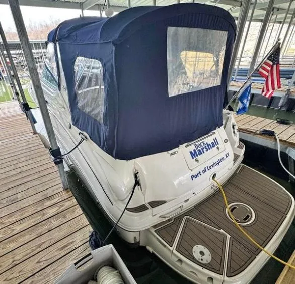 Slide: The Image of 2005 Sea Ray 280 DA docked with blue canopy and American flag. - 5