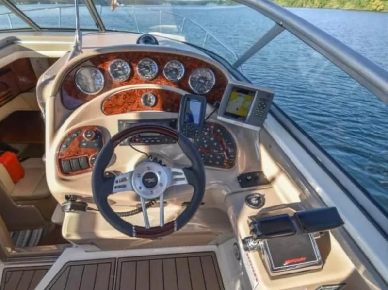 Slide: The Image of 2005 Sea Ray 280 DA boat dashboard with steering wheel and navigation instruments. - 6
