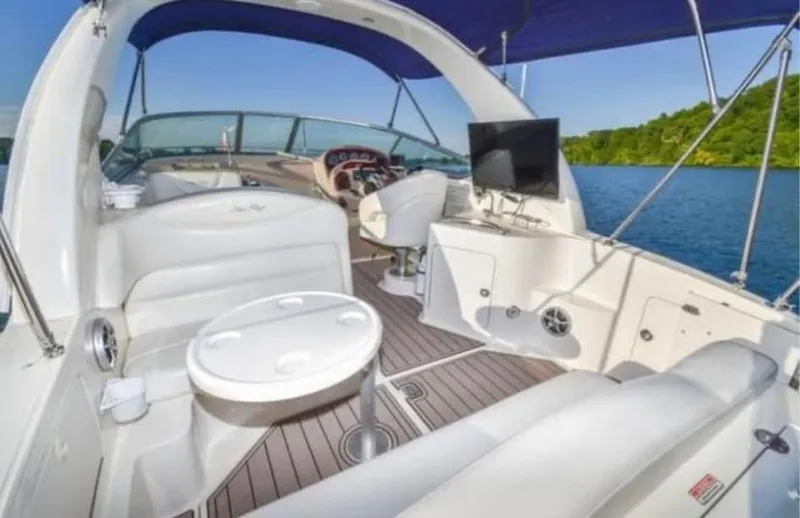 Slide: The Image of 2005 Sea Ray 280 DA boat interior with seating, table, and lake view. - 7