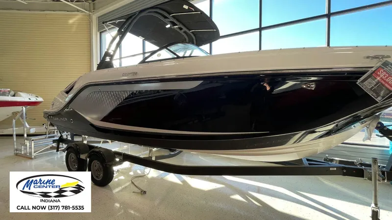 Slide: The Image of 2025 Bayliner D22I boat displayed at Marine Center Indiana showroom. - 1