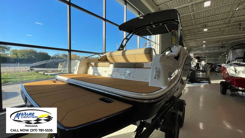 Slide: The Image of 2025 Bayliner D22I boat displayed in showroom with large windows and natural light. - 12