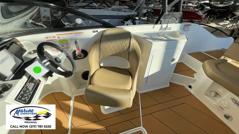 Slide: The Image of 2025 Bayliner D22I boat interior with steering wheel and seating at Marine Center Indiana. - 16