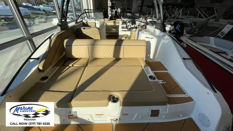 Slide: The Image of 2025 Bayliner D22I boat interior with tan seating, displayed at Marine Center Indiana. - 18