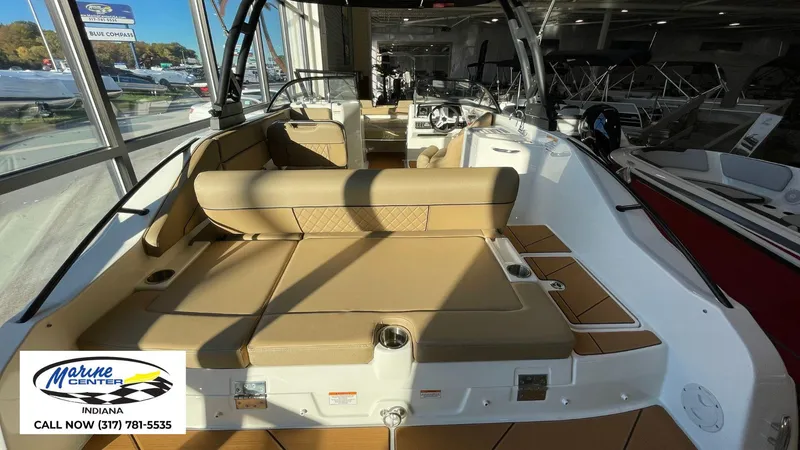 Slide: The Image of 2025 Bayliner D22I boat interior with tan seating at Marine Center Indiana showroom. - 19
