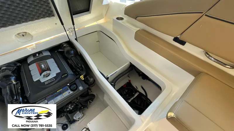 Slide: The Image of 2025 Bayliner D22I boat engine compartment with seating and storage. - 2