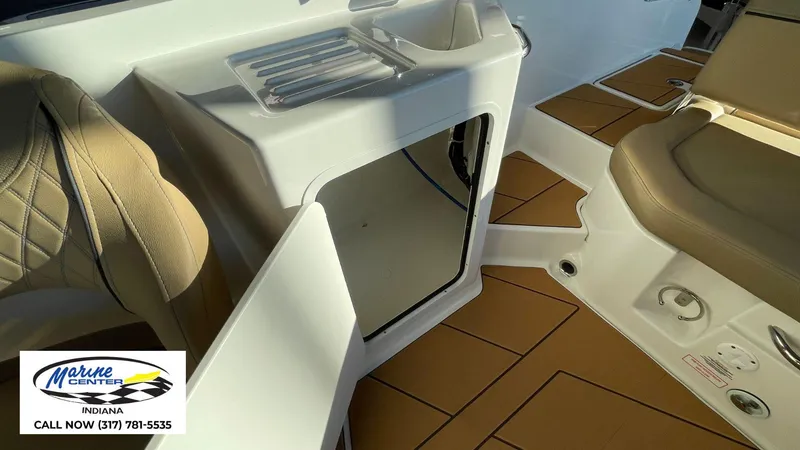 Slide: The Image of Interior of 2025 Bayliner D22I boat with seating and storage, Marine Center contact info visible. - 3