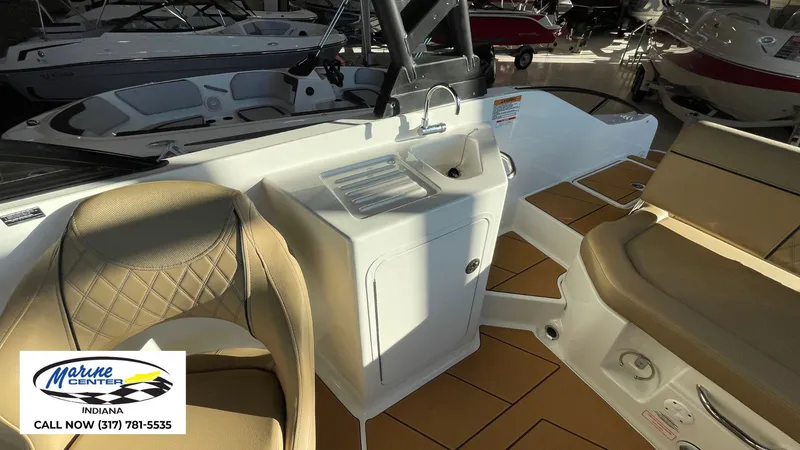 Slide: The Image of 2025 Bayliner D22I boat interior with seating and sink, displayed at Marine Center Indiana. - 5
