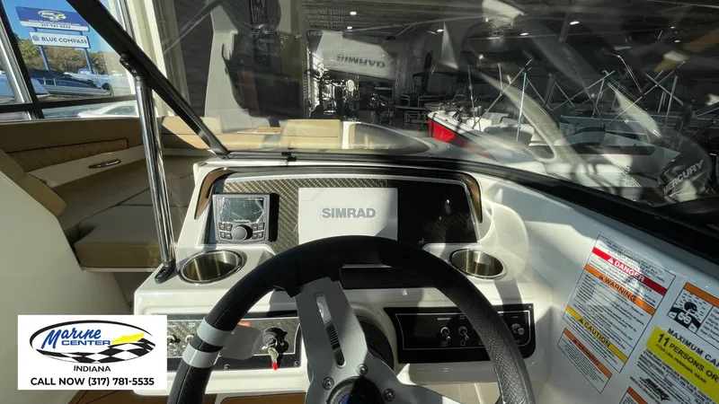 Slide: The Image of 2025 Bayliner D22I boat dashboard with Simrad display and steering wheel. - 6