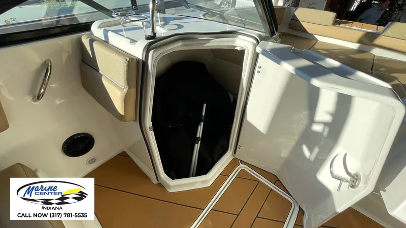Slide: The Image of 2025 Bayliner D22I boat interior storage compartment, Marine Center Indiana contact info visible. - 7