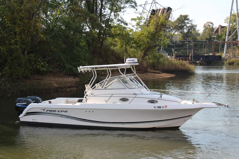 Slide: The Image of 2005 Pro-Line 29 Express boat on a calm river. - 17