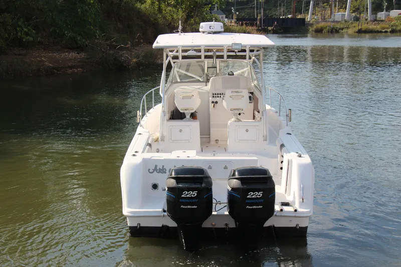 Slide: The Image of 2005 Pro-Line 29 Express boat with twin 225 horsepower engines on a calm waterway. - 3