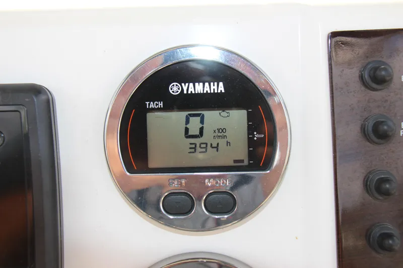 Slide: The Image of Yamaha tachometer displaying 394 hours on a 2017 Robalo R200ES boat. - 14