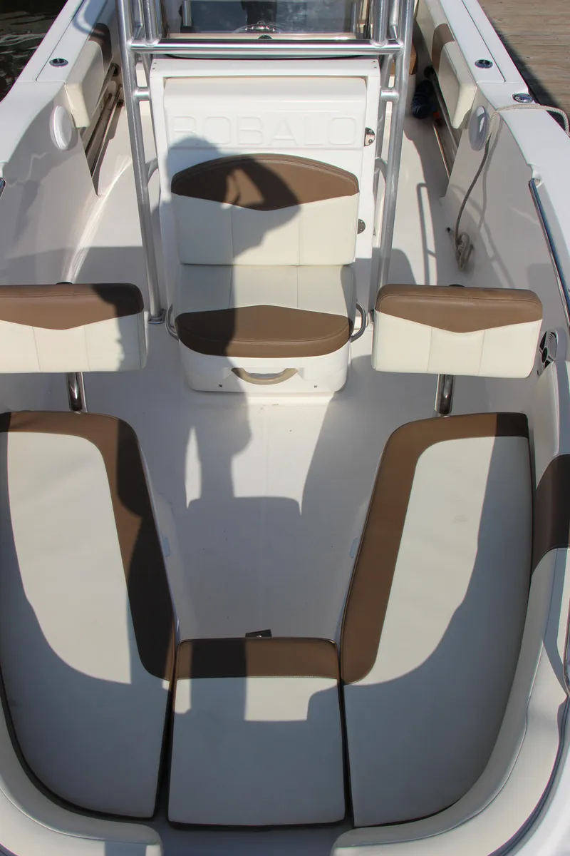 Slide: The Image of 2017 Robalo R200ES boat interior with brown and white seating. - 17