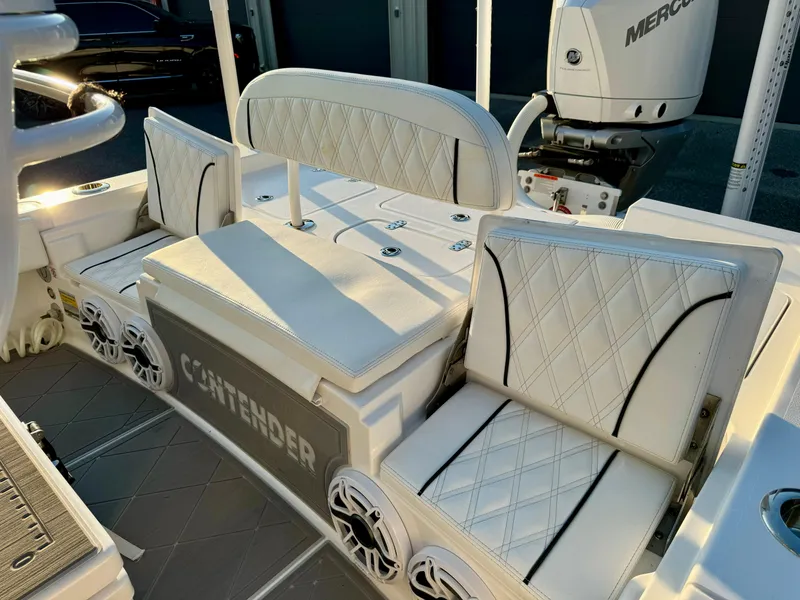Slide: The Image of 2024 Contender 26 Bay boat interior with cushioned seating and modern design. - 15