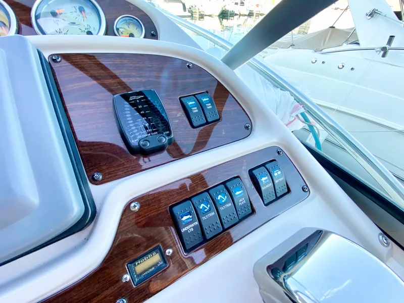 Slide: The Image of 2006 Chaparral Signature 350 dashboard with wood paneling and control switches. - 10
