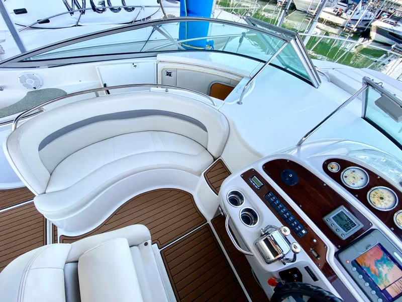 Slide: The Image of 2006 Chaparral Signature 350 boat cockpit with white seating and control panel. - 14