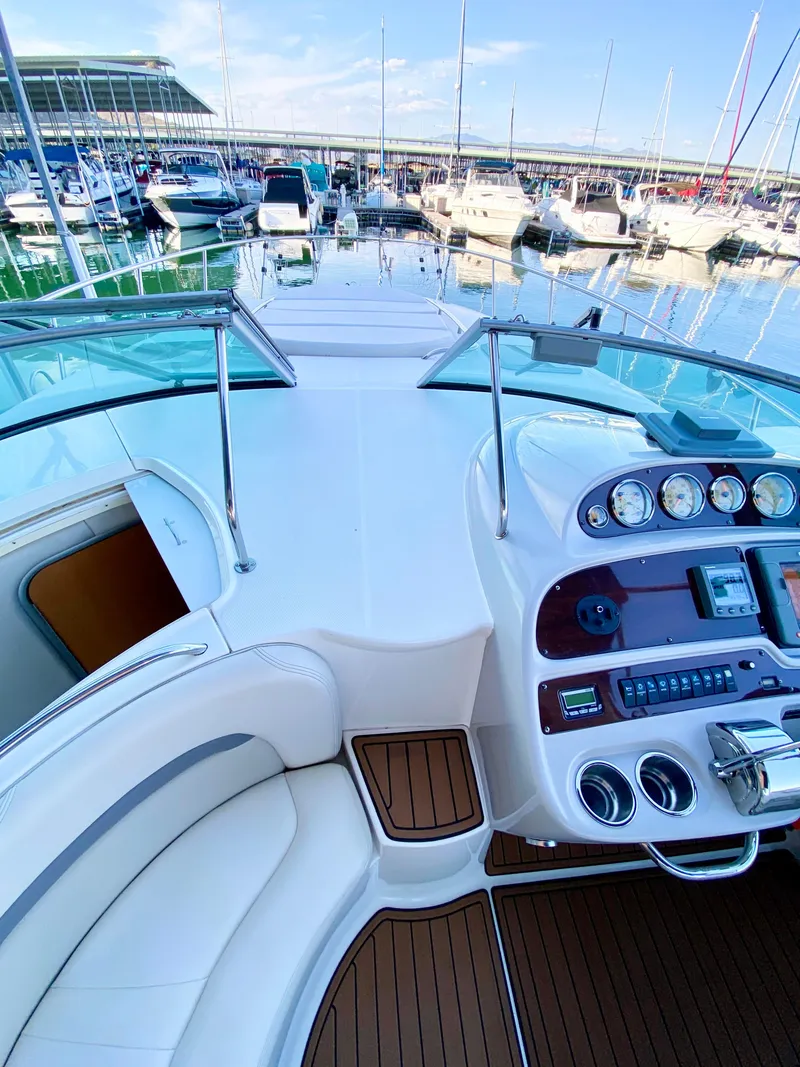 Slide: The Image of 2006 Chaparral Signature 350 yacht cockpit with marina view, featuring sleek controls and seating. - 15