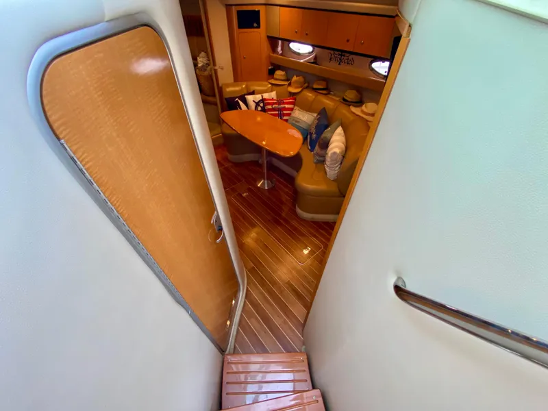 Slide: The Image of Interior view of 2006 Chaparral Signature 350 yacht, featuring wooden flooring and cozy seating area. - 16