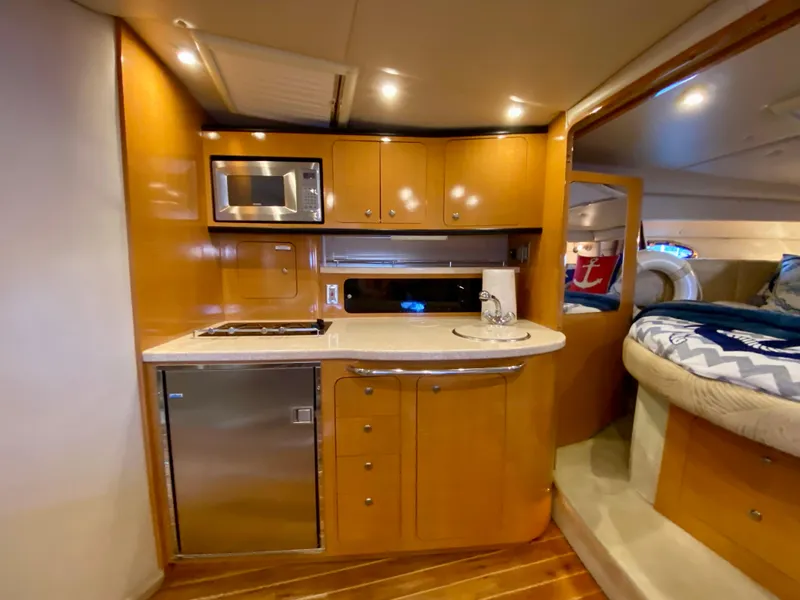 Slide: The Image of 2006 Chaparral Signature 350 yacht interior with kitchenette and cozy sleeping area. - 20