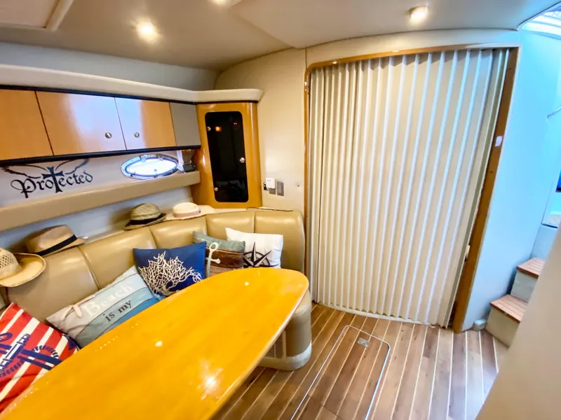 Slide: The Image of 2006 Chaparral Signature 350 interior with cozy seating, wooden table, and decorative pillows. - 28
