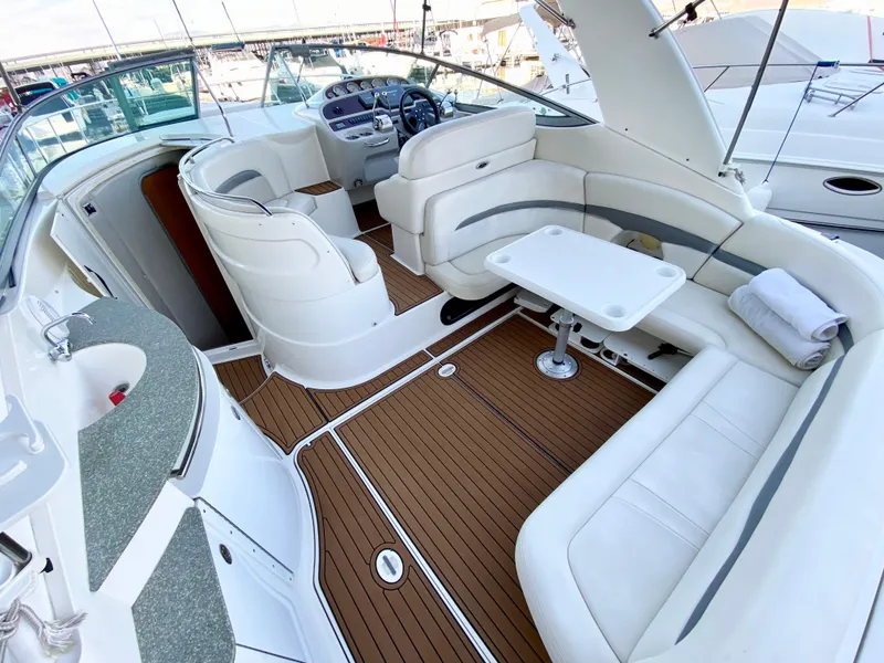 Slide: The Image of 2006 Chaparral Signature 350 yacht interior with white seating and wooden flooring. - 3
