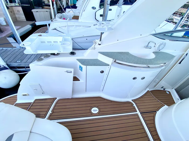Slide: The Image of 2006 Chaparral Signature 350 boat deck with wood flooring and white cabinetry. - 30