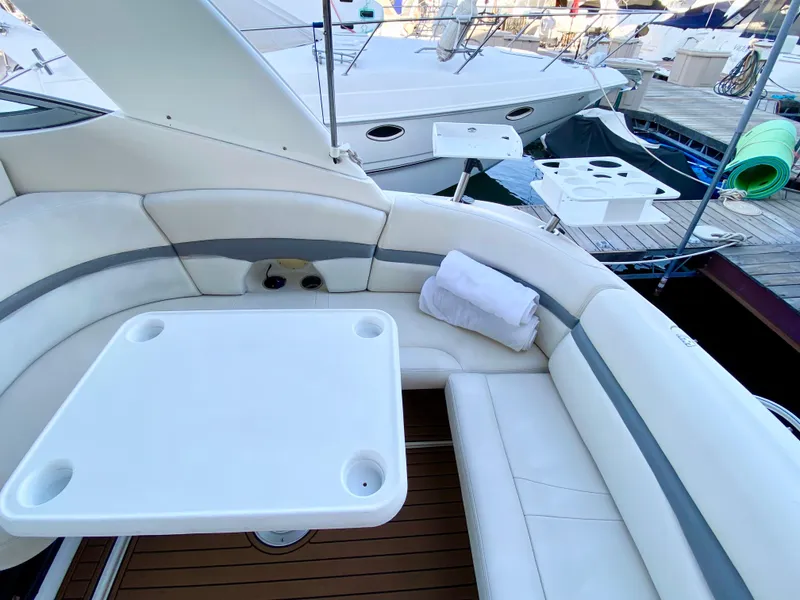 Slide: The Image of 2006 Chaparral Signature 350 yacht interior with white seating and table. - 32