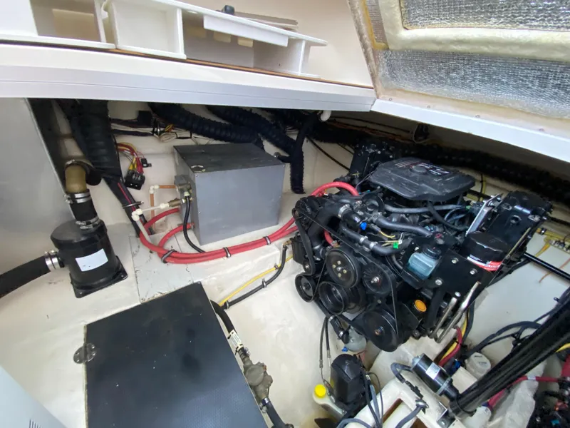 Slide: The Image of Engine compartment of 2006 Chaparral Signature 350 boat, showcasing mechanical components and wiring. - 38