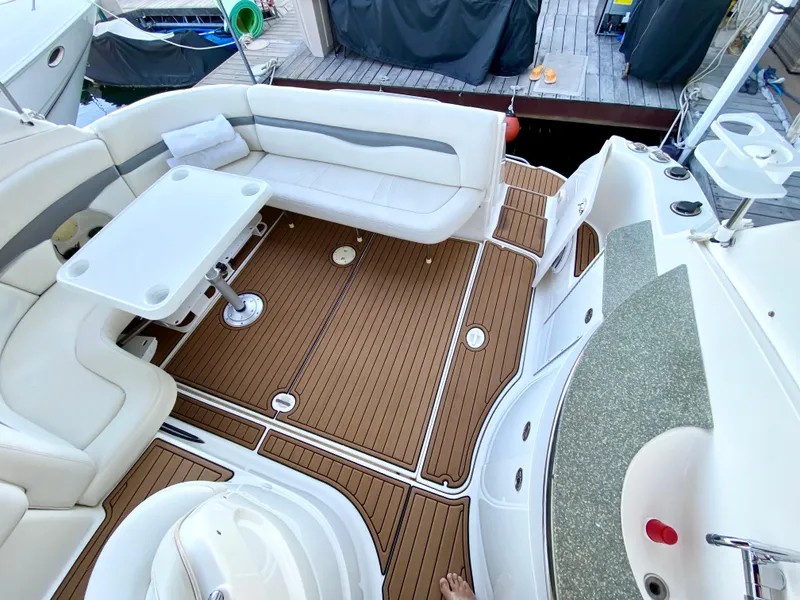 Slide: The Image of 2006 Chaparral Signature 350 boat interior with white seating and wood flooring. - 4